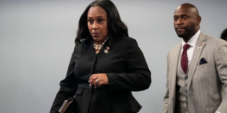 Fulton County District Attorney Fani Willis, followed by special prosecutor Nathan Wade, right, arrives for a news conference at the Fulton County Government Center, Aug. 14, in Atlanta. Willis acknowledged in a court filing on Friday having a “personal relationship” with Wade, a special prosecutor she hired for the Georgia election interference case against former President Donald Trump.