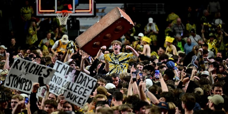 Wake Forest Demon Deacons fans storm the court after a win against Duke on Saturday at Lawrence Joel Veterans Memorial Coliseum in Winston Salem, North Carolina.