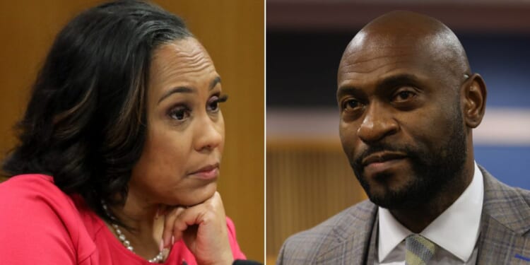 Fani Willis, left, district attorney in Georgia's Fulton County, and special prosecutor Nathan Wade, right, look on during a hearing to determine whether the two should be disqualified from the case for allegedly lying about a personal relationship.