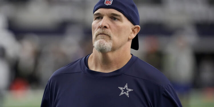 Dallas Cowboys defensive coordinator Dan Quinn watches players warm up for an NFL football game against the Washington Commanders in Arlington, Texas, on Nov. 23.