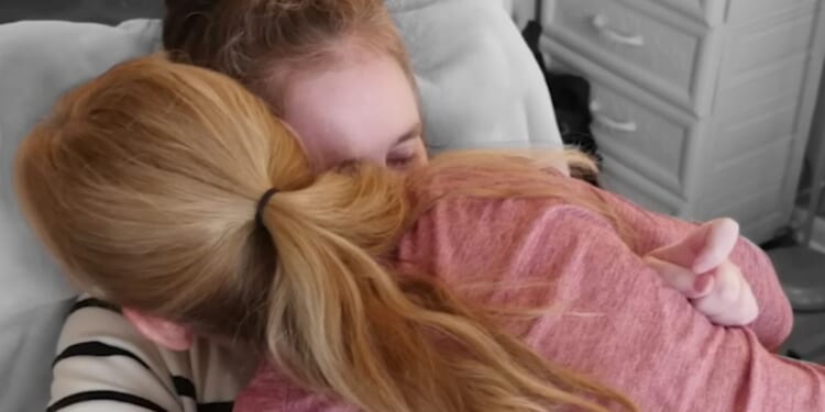 Peggy Means, top, hugs her daughter Jennifer Flewellen. Flewellen went into a coma for five years following a car accident in 2017, but despite doctors' advice to remove her from life support, Means continued to hope that God would heal her daughter, who eventually woke up from her coma in August 2022.