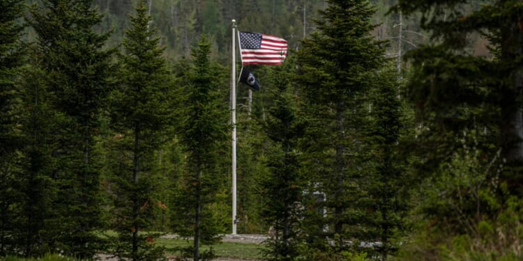 An American flag flies at Patriot Park, a collection of monuments in tribute to veterans in Columbia Falls, Maine.