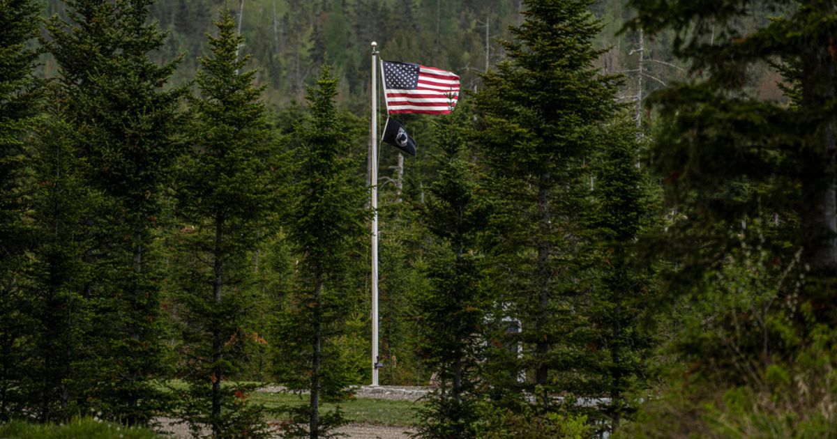 An American flag flies at Patriot Park, a collection of monuments in tribute to veterans in Columbia Falls, Maine.