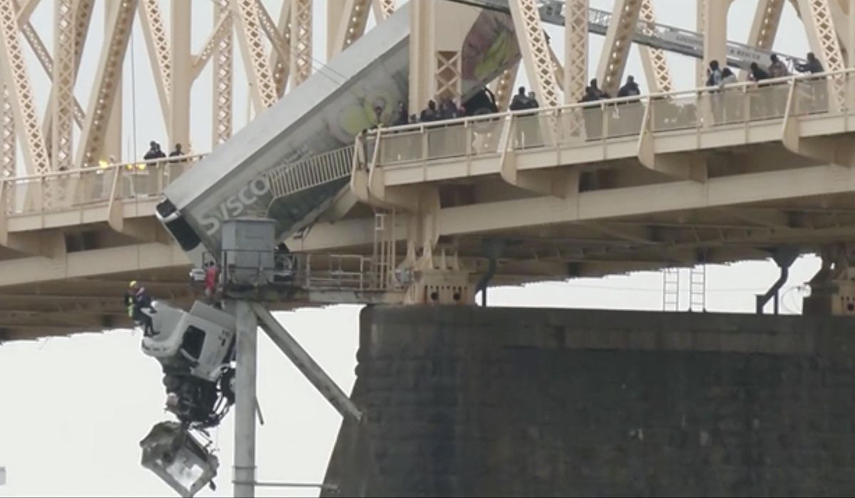 Truck driver rescued from cab dangling off a Louisville bridge