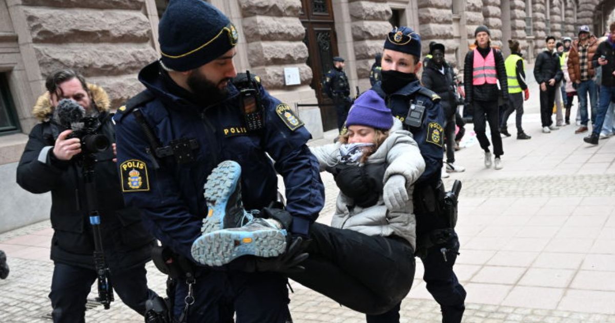 Swedish climate activist Greta Thunberg is carried away by police after staging a sit-in outside the Swedish parliament, the Riksdagen, to demonstrate for climate action, Wednesday in Stockholm, Sweden.