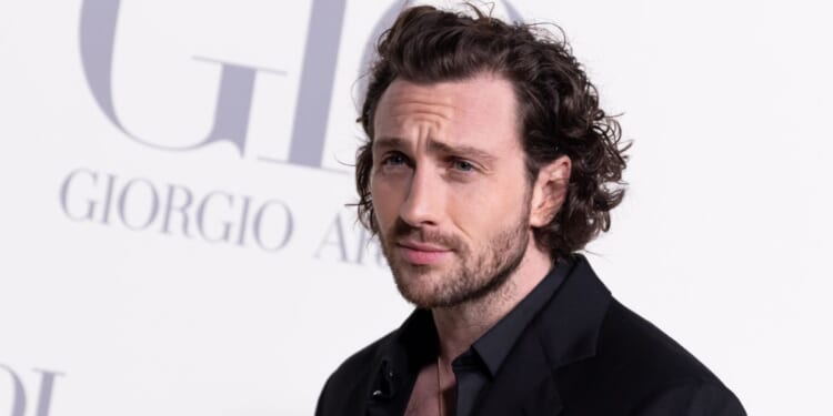 Aaron Taylor-Johnson at the Madrid photocall for "ACQUA DI GIO" at Matadero Madrid in 2024.