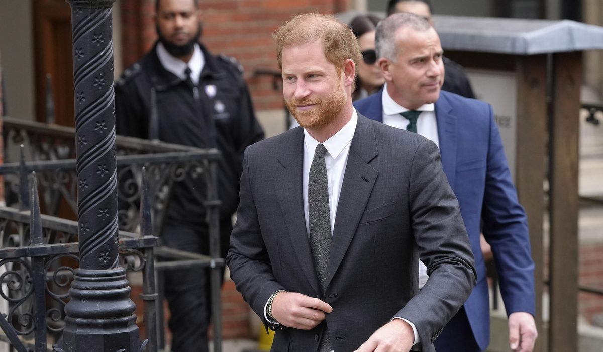 Prince Harry says tabloids intercepted phone calls of mother, the late Princess Diana, and father