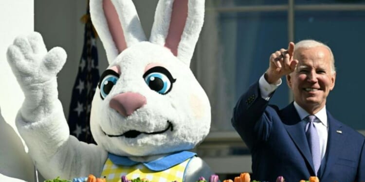 President Joe Biden, alongside the Easter Bunny, gestures after speaking at the annual Easter Egg Roll on the South Lawn of the White House in Washington, D.C., April 10, 2023.