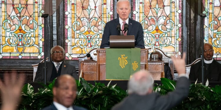 President Joe Biden watches as protesters are escorted out of the Emanuel AME Church on Jan. 8 in Charleston, South Carolina.