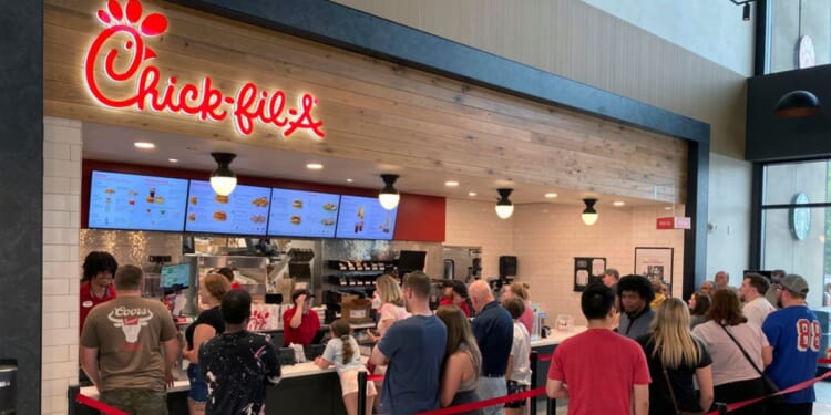 People line up to order fast food from a Chick-fil-A restaurant at the Iroquois Travel Plaza rest stop in Little Falls, New York.