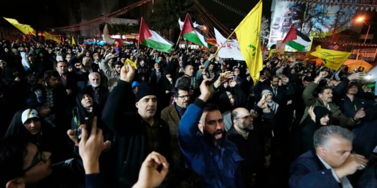 Iranian protesters chant slogans as some of them wave Palestinian flags during an anti-Israeli demonstration Sunday in downtown Tehran, Iran.