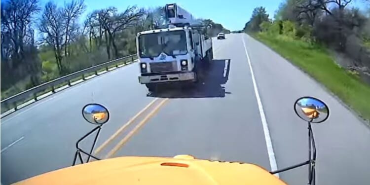 An image taken from a YouTube video shows the moment before a cement truck crashed into a school bus in Texas, killing one child on the bus and another driver on the road.