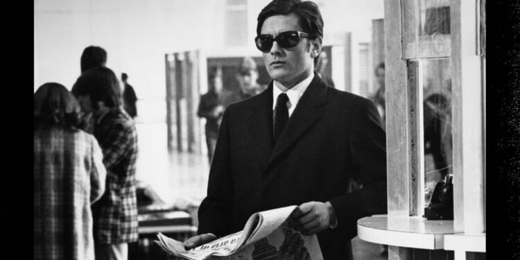 French actor Alain Delon stands in Fiumicino Airport, Rome, during the filming of 1969's 'The Sicilian Clan.'