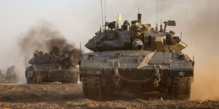 Israeli military tanks roll near the border with the Gaza Strip on Dec. 3, amid continuing battles between Israel and the militant group Hamas.