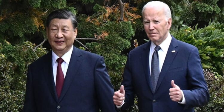 Chinese President Xi Jinping and U.S. President Joe Biden walk together after a meeting during the Asia-Pacific Economic Cooperation Leaders' week in Woodside, California on Nov. 15.