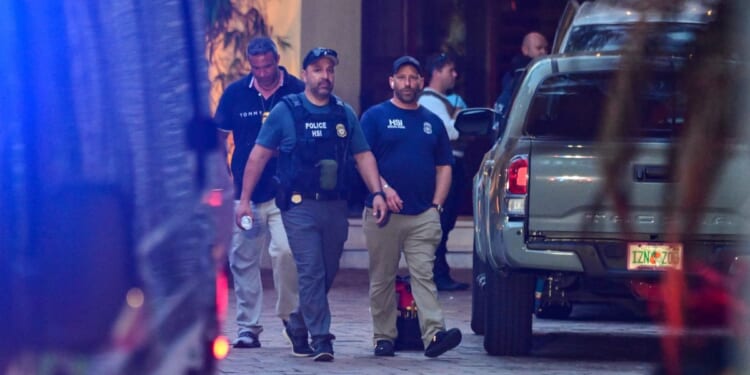 Homeland Security Investigation agents are seen at the entrance of Sean "Diddy" Combs's home at Star Island in Miami Beach on Monday.