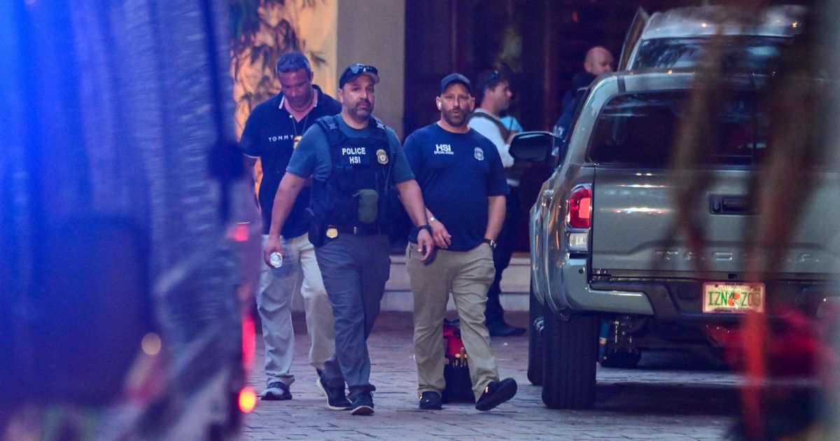 Homeland Security Investigation agents are seen at the entrance of Sean "Diddy" Combs's home at Star Island in Miami Beach on Monday.