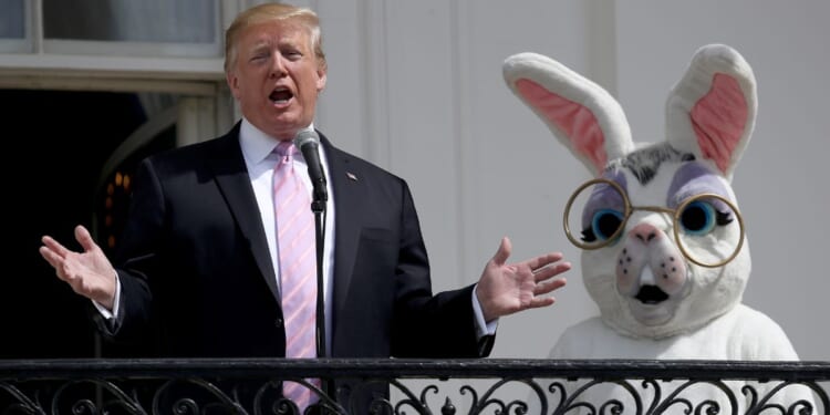 President Donald J. Trump standing next to an individual in an Easter Bunny suit in 2019.