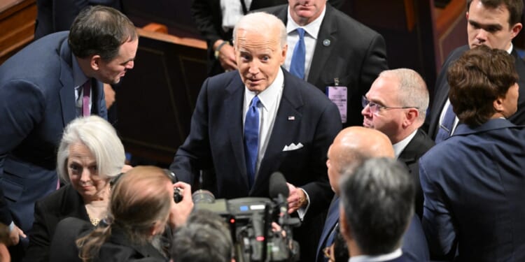 President Joe Biden gladhands after the State of the Union address March 7 in the House of Representatives chamber.