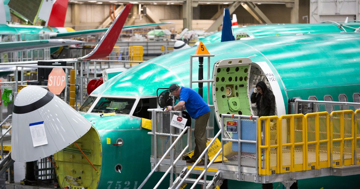 Employees work on Boeing 737 MAX airplanes at the Boeing Factory in Renton, Washington, in this file photo from March 2019.