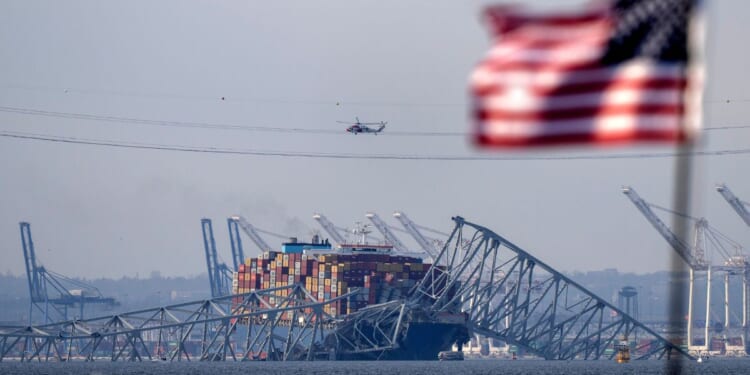 the container ship Dali resting against wreckage of the Francis Scott Key Bridge