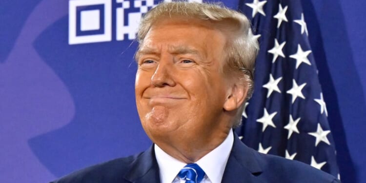 Republican presidential candidate and former President Donald Trump smiles during a campaign event at Big League Dreams in Las Vegas on Jan. 27.