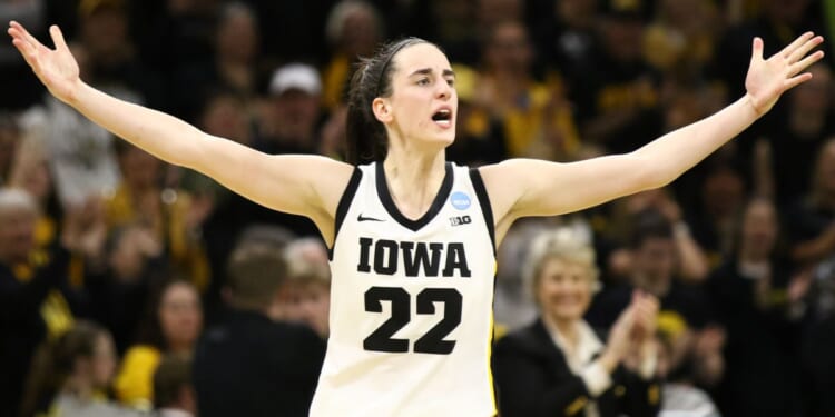 Iowa Hawkeyes' Caitlin Clark celebrates after drawing a foul late in the second half against the West Virginia Mountaineers during their second round match-up in the 2024 NCAA Division 1 Women's Basketball Championship in Iowa City, Iowa, on Monday.