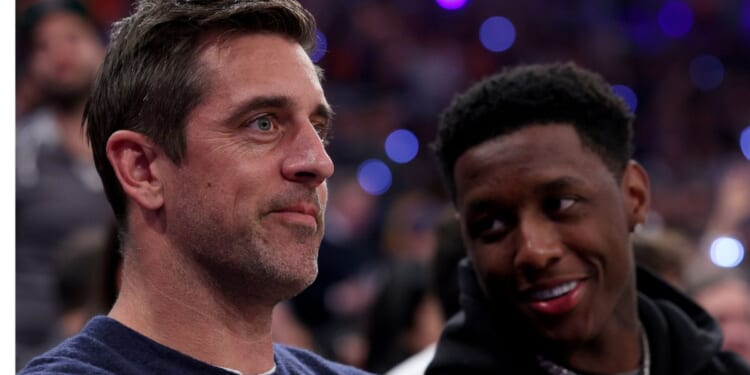 New York Jets players Aaron Rodgers, left, and Sauce Gardner, right, attend game two of the Eastern Conference Semifinals between the New York Knicks and the Miami Heat in New York City on May 2, 2023.