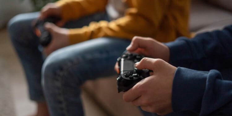 This stock image shows two boys playing video games.