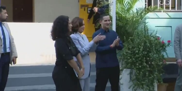 Vice President Kamala Harris claps to a band's music Friday in San Juan, Puerto Rico.