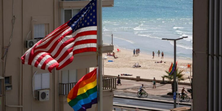 A U.S. flag is seen raised alongside a "pride" flag at the U.S. Embassy in Tel Aviv, Israel, in 2014.