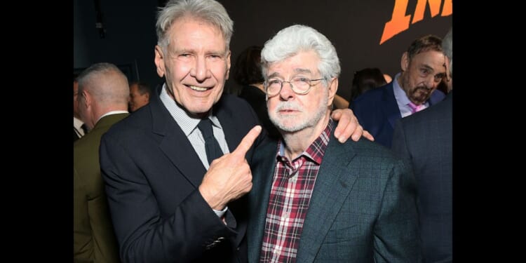 Star Wars creator George Lucas pictured next to movie star Harrison Ford at the premiere of "Indiana Jones and the Dial of Destiny."