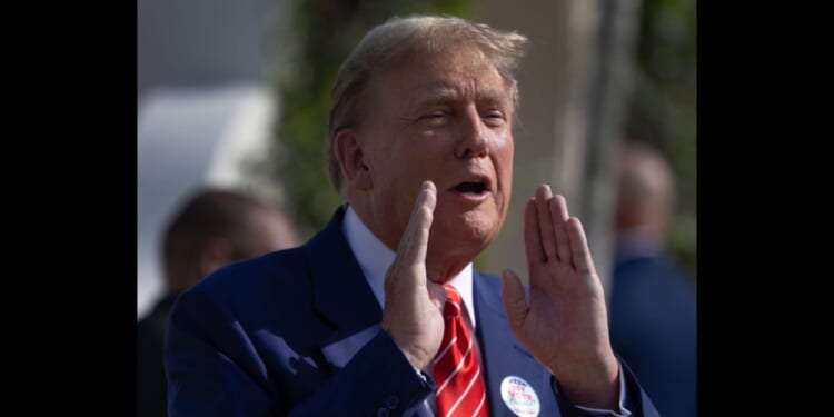 Former U.S. President Donald Trump speaks to the media Tuesday after voting at a polling station in Palm Beach, Florida.