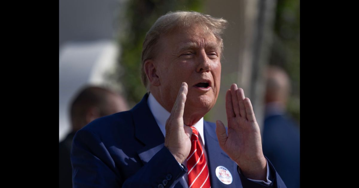 Former U.S. President Donald Trump speaks to the media Tuesday after voting at a polling station in Palm Beach, Florida.