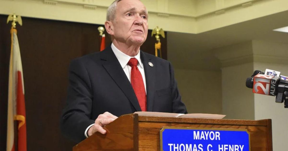 Fort Wayne Mayor Tom Henry speaks with reporters and his staff in the Indiana city on Feb. 26. Henry announced during the day that he had been diagnosed with late-stage stomach cancer. Henry died on Thursday.