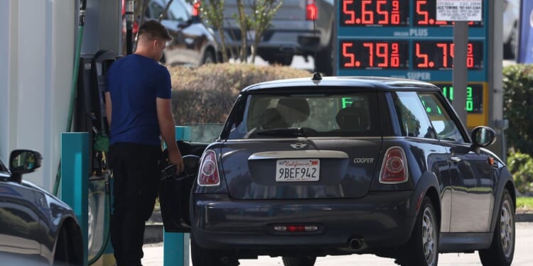 A customer pumps gas at a gas station in Petaluma, California, on Sept. 13.