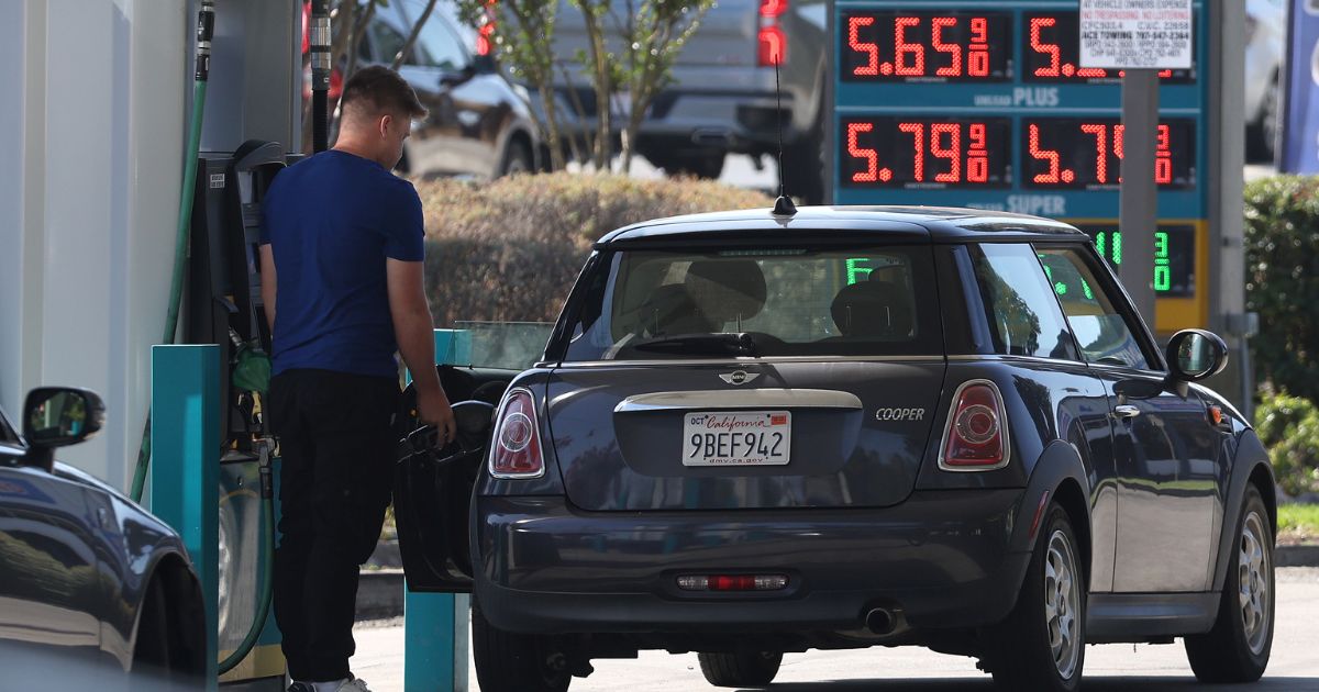 A customer pumps gas at a gas station in Petaluma, California, on Sept. 13.