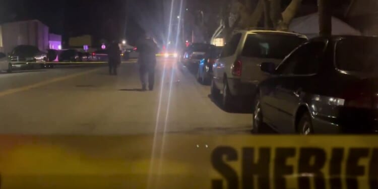 Police work the scene of a shooting at a house party in King City, California, on Sunday.