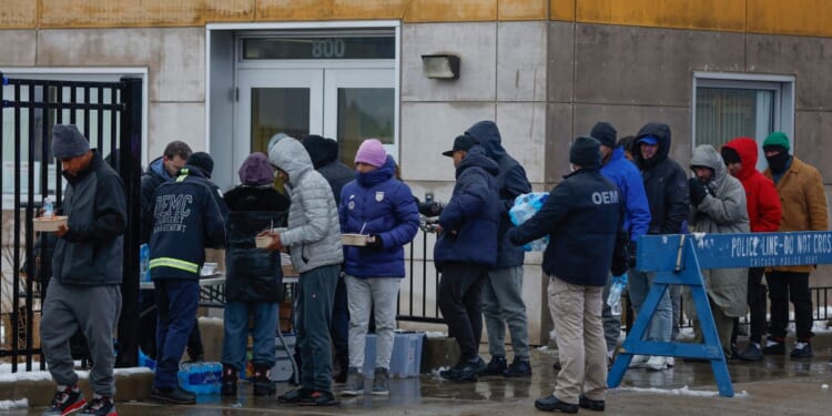 Migrants line up for free food after arriving in Chicago on Jan. 12.