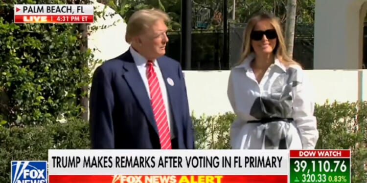 Former first lady Melania Trump smiles as she appears with her husband, former President Donald Trump, outside a polling site in Palm Beach, Florida, on Tuesday.