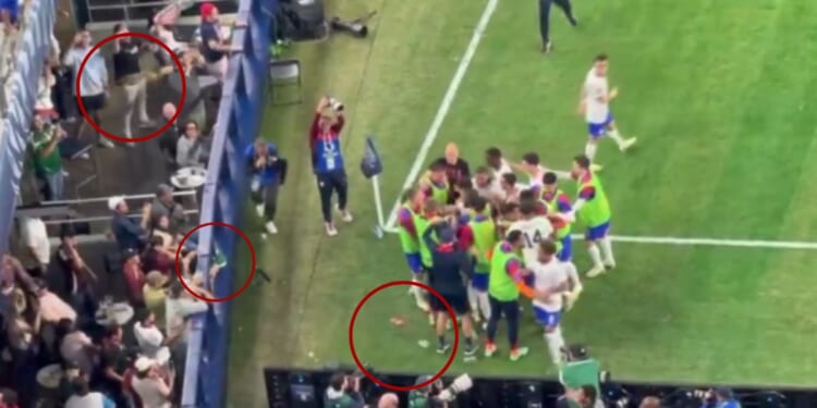 After the U.S. men's soccer team scored their second goal in their game against Mexico on Sunday, Mexican fans threw beer, circled, at them as they gathered to celebrate.