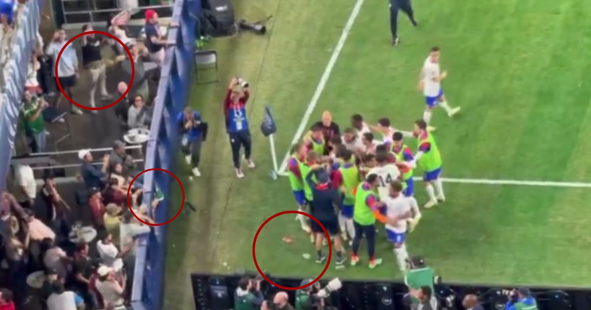 After the U.S. men's soccer team scored their second goal in their game against Mexico on Sunday, Mexican fans threw beer, circled, at them as they gathered to celebrate.