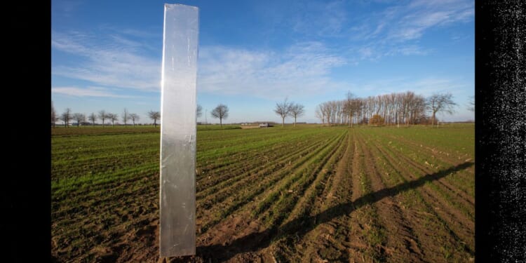 A file photo taken Dec. 10, 2020, shows a mysterious metal monolith, similar to others appearing in Europe and USA, that was discovered in a field in Assenede, Belgium. Several mysterious metal monoliths appeared around the same time on a heath in the Netherlands, in the Utah desert, in Romania and in Britain. Now, a similar object has appeared in Wales.