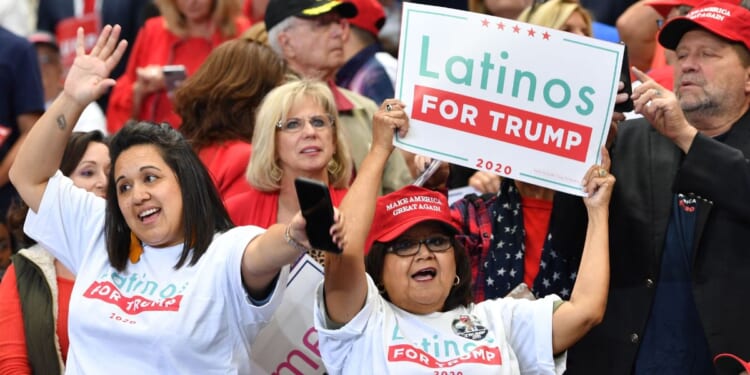 A supporter of then-President Donald Trump hold a sign reading "Latinos for Trump" at a "Keep America Great" rally in Dallas, Texas, in a file photo from October 2019.