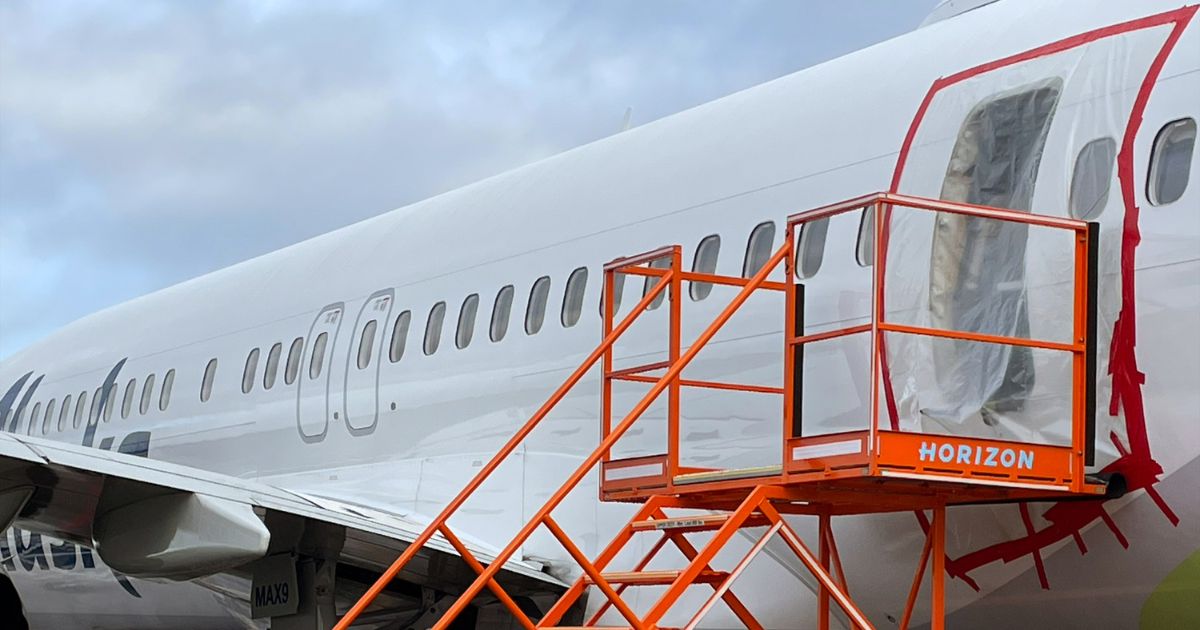 Plastic covers the exterior of the fuselage plug area of Alaska Airlines Flight 1282 on Jan. 7 in Portland, Oregon. A piece of the fuselage of the Boeing 737 MAX 9 plane blew off after the flight left Portland on Jan. 5 en route to Ontario, California.