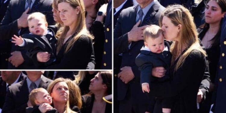 The wife of slain police officer Jonathan Diller, Stephanie, and their son, Ryan, at Jonathan's funeral Saturday.