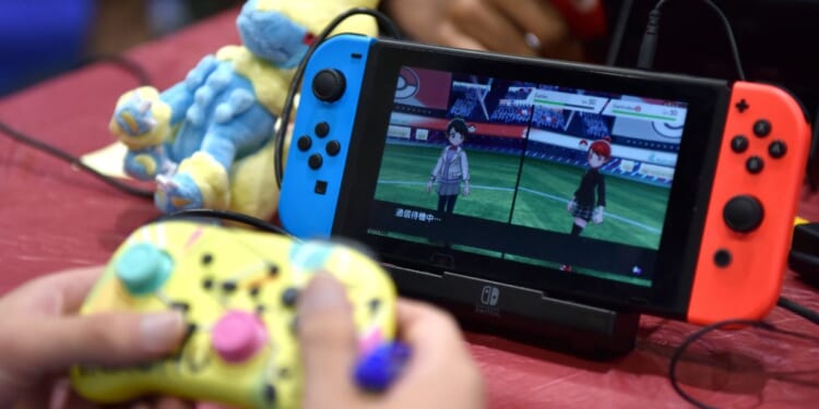 A competitor plays Pokemon on a Nintendo Switch console during the 2022 Pokémon World Championships at ExCel on August 18, 2022 in London, England.