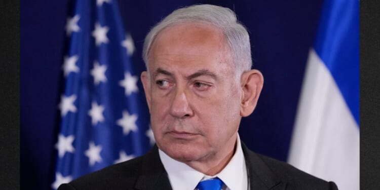 Israeli Prime Minister Benjamin Netanyahu looks on as U.S. Secretary of State Antony Bilnken gives statements to the media inside The Kirya, which houses the Israeli Defence Ministry, after their meeting in Tel Aviv on October 12, 2023.