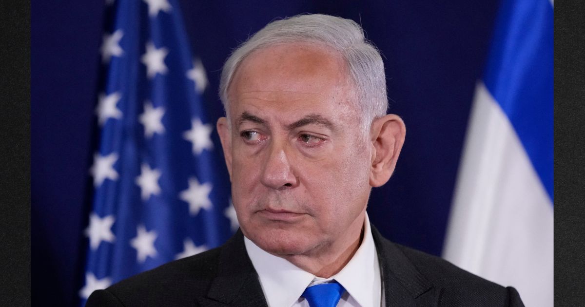 Israeli Prime Minister Benjamin Netanyahu looks on as U.S. Secretary of State Antony Bilnken gives statements to the media inside The Kirya, which houses the Israeli Defence Ministry, after their meeting in Tel Aviv on October 12, 2023.