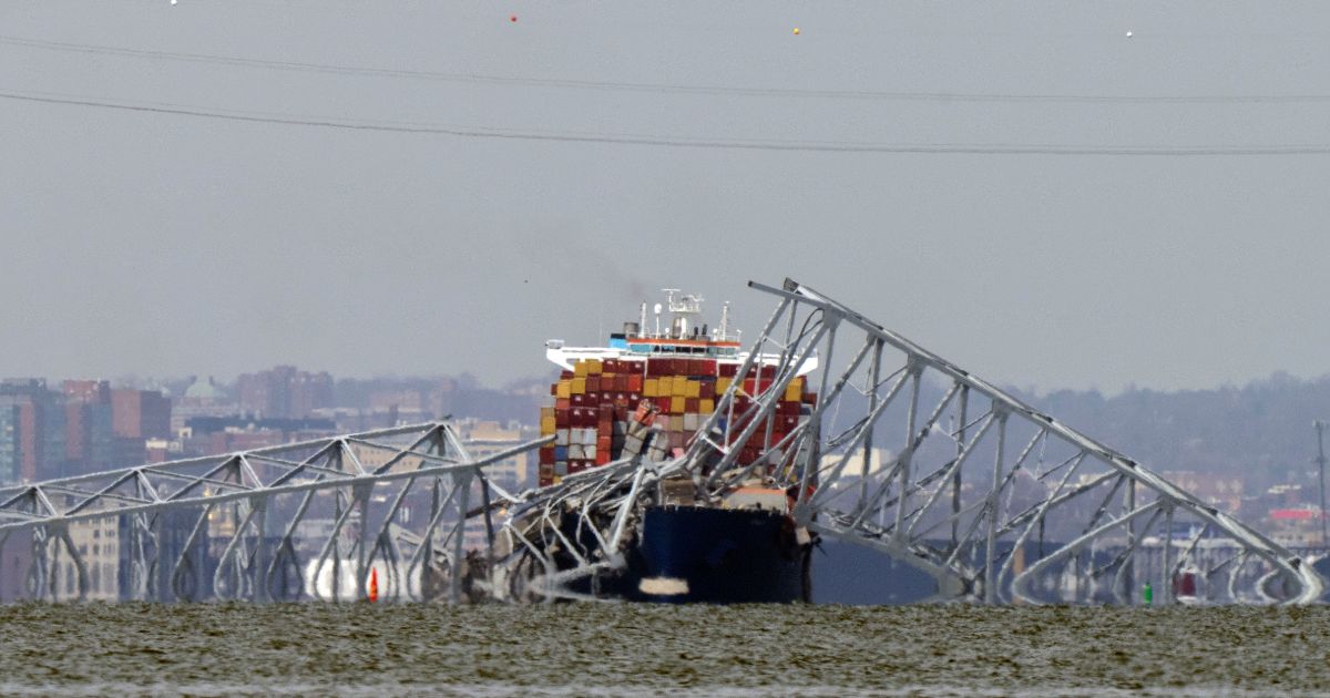 A container ship rests against wreckage of the Francis Scott Key Bridge in Baltimore, Maryland, on Tuesday.